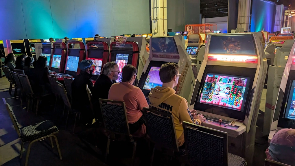 A row of Blast City and Vewlix cabinets with various arcade games at Super Magfest 2026, including Super Puzzle Fighter II Turbo closest to the camera.